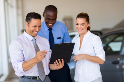 group of happy car sales